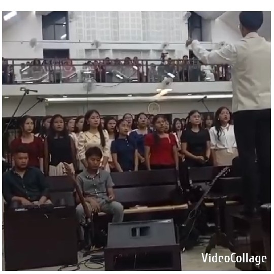 Choir Practicing Under Conductor's Guidance