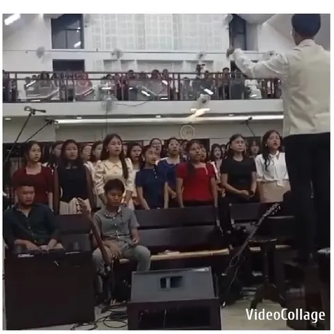 Choir Practicing Under Conductor's Guidance