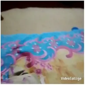 Bed Covered With Colorful Floral Blanket