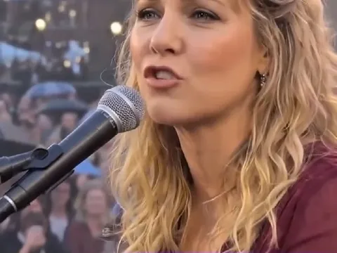Woman Singing Outdoors to Crowd