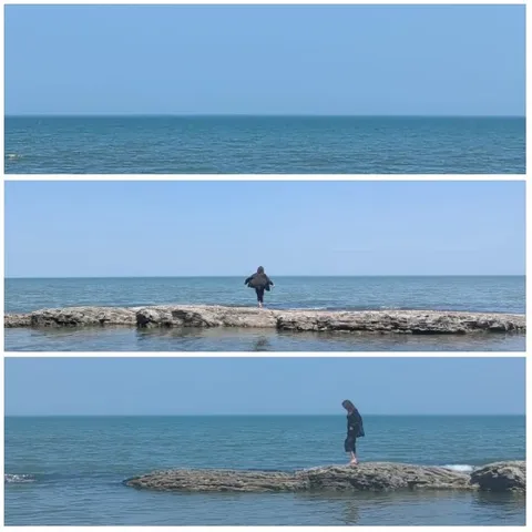 Person by Sea on Rocky Outcrop