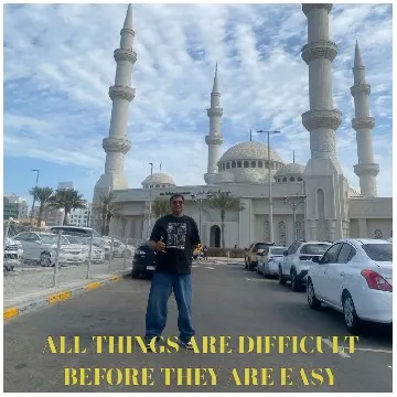 Man in Parking Lot by Mosque