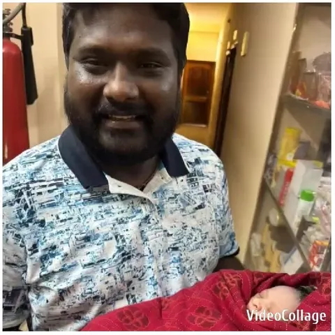 Man Holding Baby Indoors