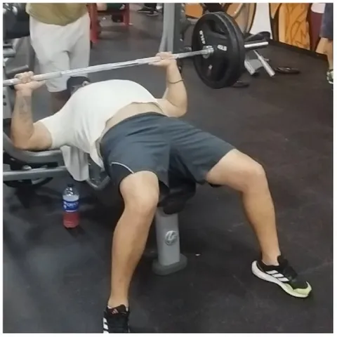Person Lifting Barbell in Gym