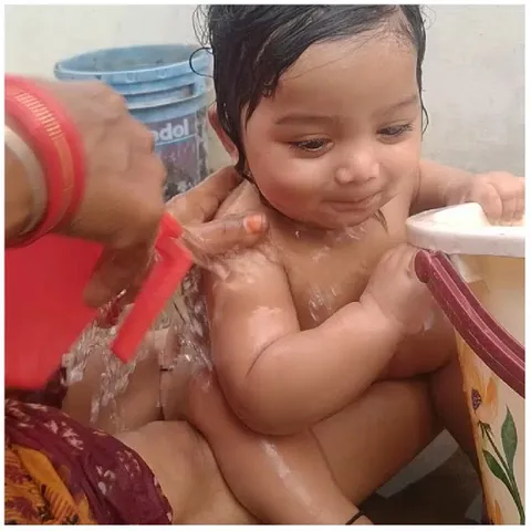 Happy Baby Being Bathed