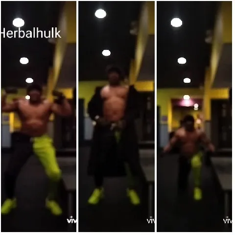 Flexing Muscles in Dim Gym