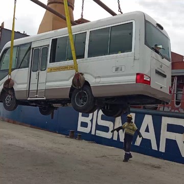 Crane Lifting White Bus