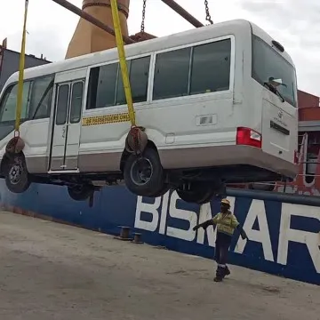 Crane Lifting White Bus