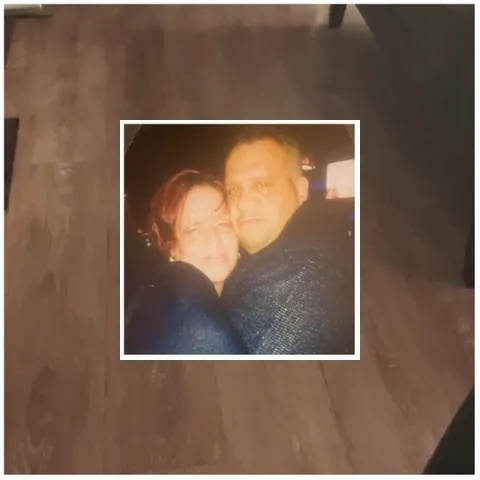 Couple Embracing on Wooden Floor