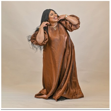Person in Brown Dress Adjusting Hair