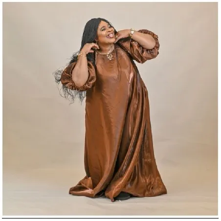 Person in Brown Dress Adjusting Hair