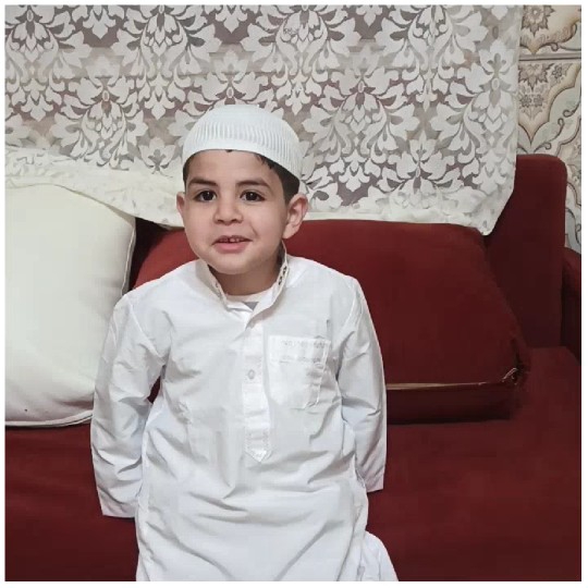 Young Boy on Red Couch