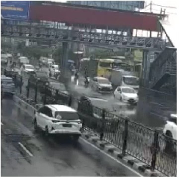 Busy Urban Street in Rain