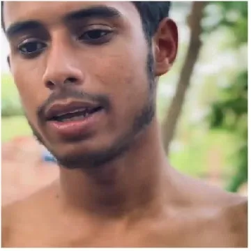 Young Man Outdoors with Greenery