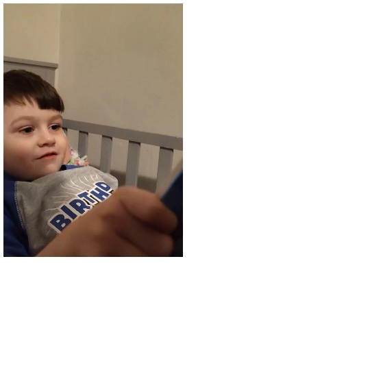 Child Holding a Book in Bed