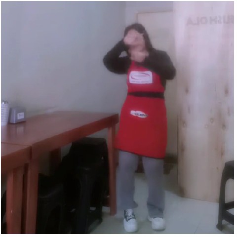 Person in Red Apron Gesturing