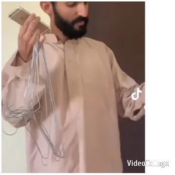 Man Holds Smartphone and Hangers