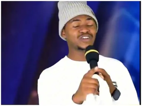 Person Singing in White Sweater