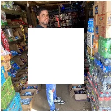 Person in Small Shop of Goods
