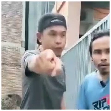 Two Men Posing Near a Fence