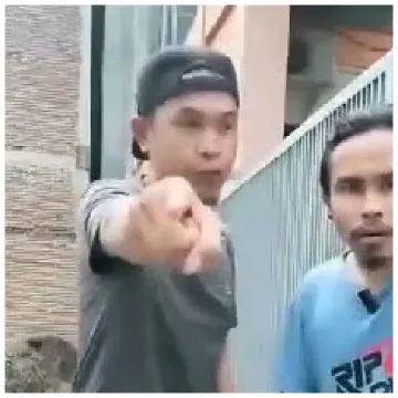 Two Men Posing Near a Fence