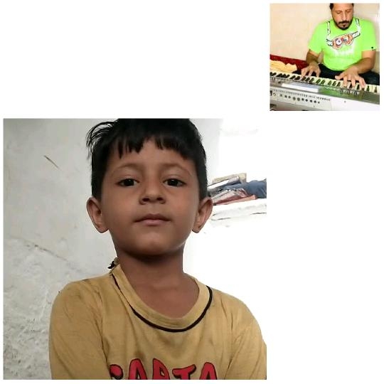 Child Looking at Camera and Keyboard