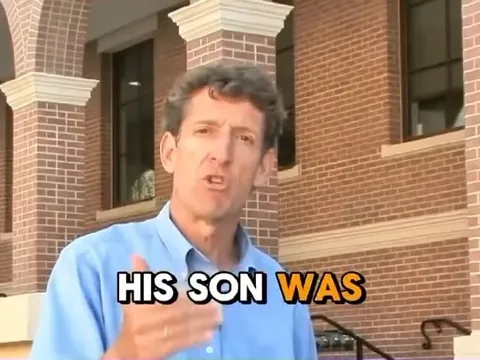 Man Speaking by Brick Building