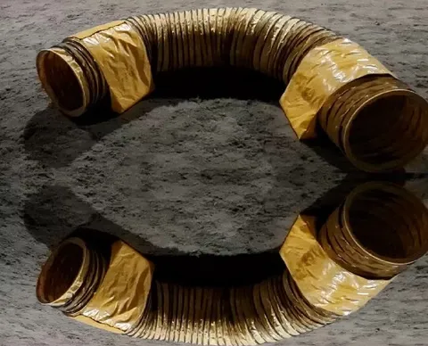 Coiled Yellow Duct on Rough Surface
