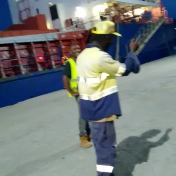 Workers Near Large Ship Outdoors