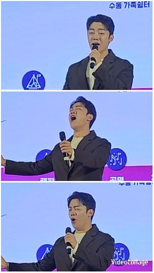 Suit-Clad Performer Singing on Stage