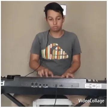 Person Playing Keyboard in Gray T-Shirt