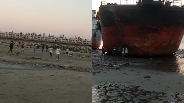 Busy Beach Scene with Grounded Ship