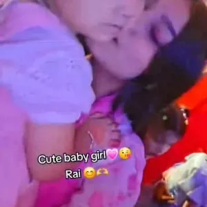 Mother Kissing Baby in Pink