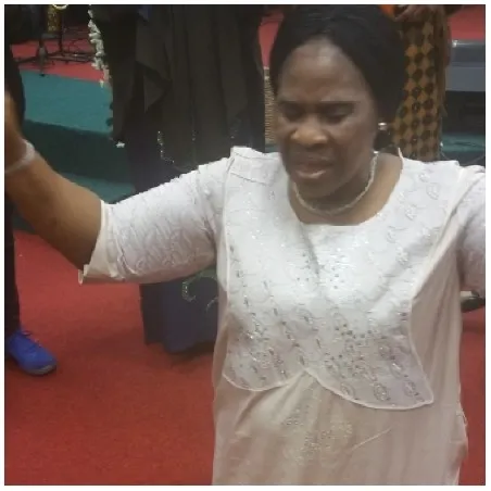 Person in Prayer with Arms Raised