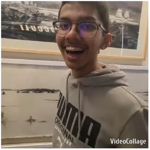 Person Smiling in Front of Art