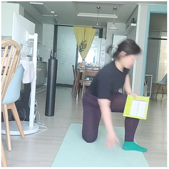 Kneeling Person with Booklet