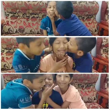 Children Sharing Affection on Sofa