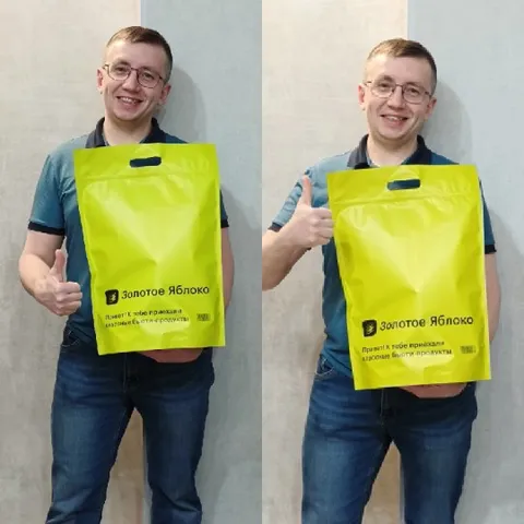 Person Smiling with Yellow Bag