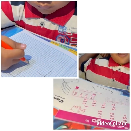 Child Writing with Open Book