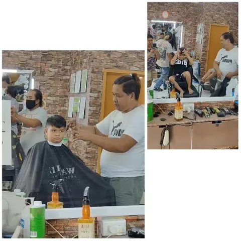 Barber Cutting Young Boy's Hair