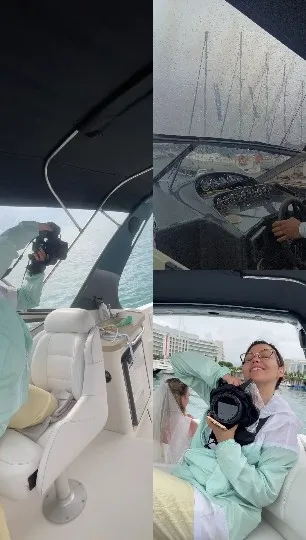 Person Smiling On Boat During Rain