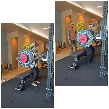 Person Performing Squat Lift in Gym