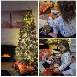Child Opening Gift by Tree