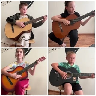 Children Playing Guitar in a Room