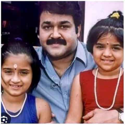 Smiling Man with Two Girls