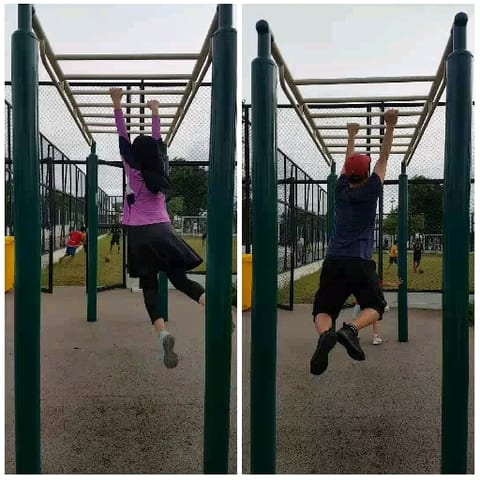 People on Monkey Bars at Playground