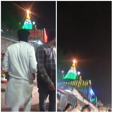 People Approaching Illuminated Structure