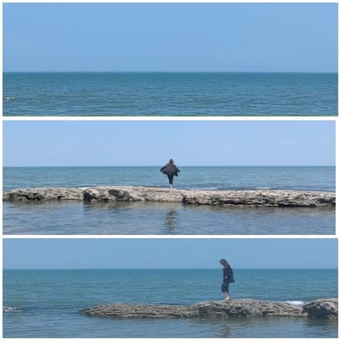 Walking on Rocky Shore by Ocean