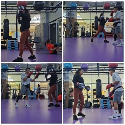 Two People Sparring in Boxing Gym