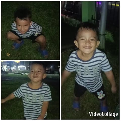 Child Smiling Outdoors at Night